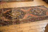 Geometric border and secured fringe detail on a distressed Anatolian runner corner.