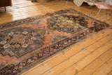 Distressed texture and faded geometric patterns on an Anatolian rug runner's secured border.