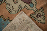 Corner of distressed Oushak rug runner, showing textured pile and hand-knotted foundation.