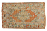 Distressed vintage Oushak rug with a terra cotta medallion, muted multi-color floral borders, 3'3