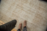 Textured vintage distressed Oushak carpet, showcasing lazy lines and worn foundation aesthetic.