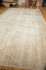 Textured detail of vintage distressed Oushak carpet showing wear, lazy lines, and foundation.