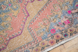 Distressed Vintage Oushak rug, European-influenced primitive florals in blush, slate blue, and fuchsia.