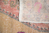 Distressed Oushak rug pile texture, original selvage, and sturdy hand-knotted foundation.