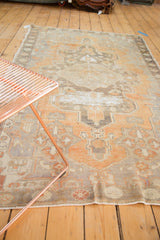 Distressed pile texture showcasing geometric patterns in dusty terra cotta and grey tones.