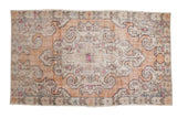 Faded burnt orange vintage Oushak rug with ivory scalloped medallion, 4'3