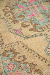 Even wear across the knot heads of a distressed Oushak rug with pink and slate blue motifs.