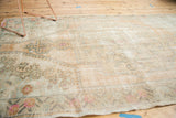 Distressed Oushak rug showing low pile, mostly foundation, with faded peach and seafoam green.
