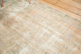 Distressed vintage Oushak rug showing heavy wear, exposed foundation, and faded peach, pink patterns.