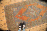Vintage Oushak runner corner, oxidized silver ground, burnt orange field, and stylized tree motif.