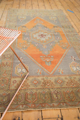Vintage Oushak runner with a stepped medallion, corner tree motifs, and burnt orange, silver palette.