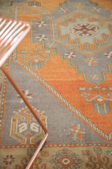 Vintage Oushak runner's burnt orange field with stepped oxidized silver geometric patterns.