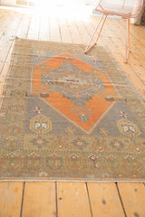 Burnt orange Oushak rug border with planted tree motif and geometric patterns.
