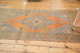 Vintage Oushak runner's burnt orange field, grey stepped contour, and patterned end border.