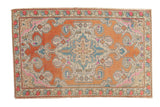 Vintage Distressed Oushak rug, terra cotta field, bold scrolling medallion, and pastel accents, 4'8