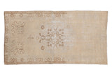 Distressed vintage Oushak runner with ivory field, pale brown medallion, worn texture, 3'1