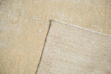 Distressed ivory pile texture of vintage Oushak rug runner, showing its hand-knotted foundation.