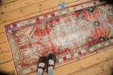 Distressed Oushak hand-knotted runner corner with starburst spandrels, serpent border.