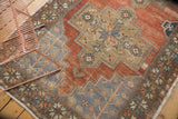 Distressed vintage Oushak runner corner, slate blue germinating plant motif, madder red field.