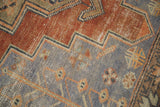Vintage distressed Oushak runner detail with slate blue, madder red geometric zigzag pattern.