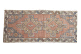 Faded geometric double medallion Oushak runner in dusty rose, sand, and slate gray tones.