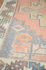 Distressed dusty rose field, slate blue-gray stepped spandrel, and geometric main border.