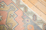 Distressed Oushak runner showing original side cord selvage and geometric serrated leaf border.