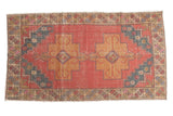 Distressed vintage Oushak rug, cranberry red field, dusty gold double medallions, primitive drawing.