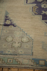Hand-knotted Oushak runner edge showcasing faded teal, ivory, and charcoal abrashes.