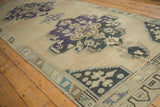 Oushak runner corner, geometric border, ivory field with faded charcoal and purple abrash.