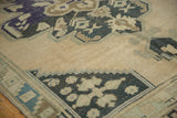 Faded charcoal, pale teal zigzag border and geometric motif on vintage Oushak rug.
