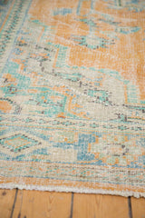 Distressed vintage Oushak rug with worn pile, revealing exposed foundation in tangerine, blue, and mint green.