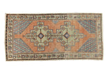 Distressed vintage Oushak runner with apricot field, blue spandrels, double geometric medallions. 3'9
