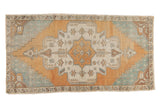 Distressed Vintage Oushak rug, oversized scalloped medallion, corner spandrels, aqua, ivory, burnt orange.