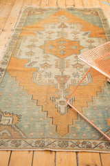 Stepped patterns and muted tones on a distressed vintage Oushak rug field.