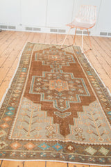 Vintage Oushak runner's corner, with germinating plant spandrel in copper and teal.