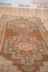 Distressed bronze field with ornate copper and teal floral medallion.