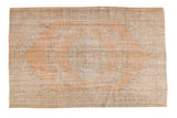Distressed vintage Oushak carpet, apricot field with faded floral medallion and vinery, 6'4