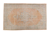 Vintage distressed Oushak carpet, apricot field, pale blue floral medallion, mint green spandrels, 6x10.