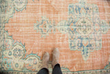 Distressed Oushak rug showing even wear to knot heads and exposed foundation.
