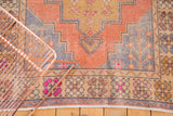 Vintage Distressed Oushak corner detail, vibrant hot pink floral border with worn orange pile.