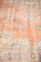 Distressed pile texture of vintage Oushak carpet with faded tangerine, blue, and green.
