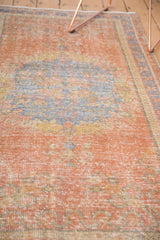 Distressed vintage Oushak runner texture, dusty grapefruit red, slate blue, visible foundation.
