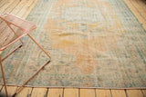 Distressed vintage Oushak carpet with worn pile, visible foundation, and soft apricot tones.
