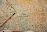 Distressed Oushak carpet's texture showing mostly even wear and exposed foundation in pale apricot, mint.