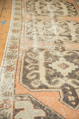 Distressed Oushak runner, worn terra cotta, ivory, and charcoal geometric patterns.