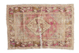 Distressed vintage Oushak square rug with serrated medallion, dusty purple, and pale beige.