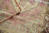 Distressed Oushak rug, dusty purple and pale beige, with wear to knot heads.