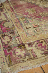 Textured hand-knotted vintage Oushak pile with dusty purple and time-softened neutral tones.