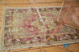 Distressed Oushak rug featuring serrated medallion, germinating plants, dusty purple, and pale beige worn pile.
